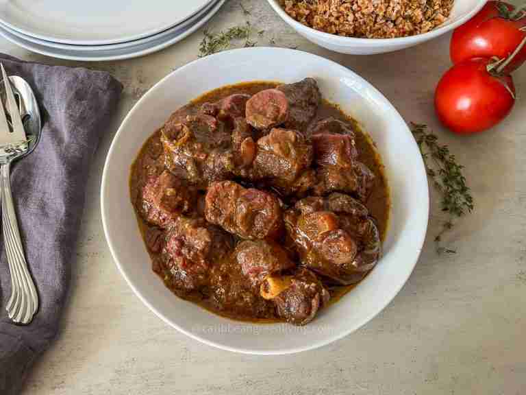 Curry Goat with Purple Sweet Potatoes and fresh herbs